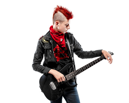 Portrait of teen boy with red haired Mohawk and guitar in leather jacket.Isolated.の写真素材
