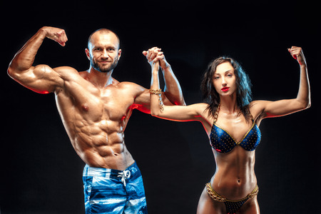 Shirtless Muscle Man Posing With Gorgeous Bikini Womanの写真素材