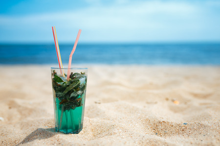 Glass of fresh mojito cocktail on the beachの写真素材