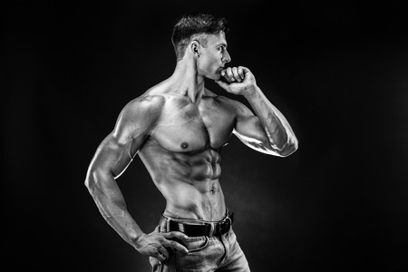 bodybuilder posing. Beautiful sporty guy male power. Fitness muscled manの写真素材