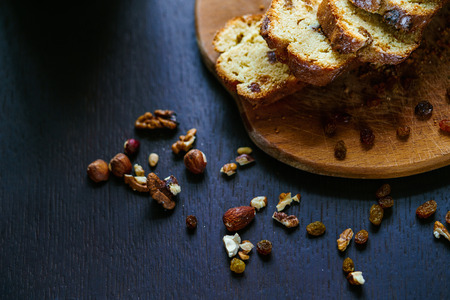 Served plate with baked bread with raisins and nuts cut into slices.の写真素材