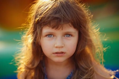 Portrait of a beautiful little girl looking at camera emotionally smiling. Close-upの写真素材