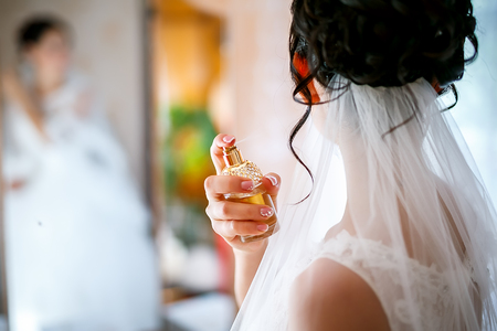 young bride uses her expensive perfume on her neck. selective focus.の写真素材