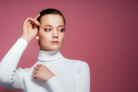 Beautiful woman face with perfect skin close up studio on pinkの写真素材