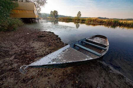 Boat on river at beautiful summer sunrise.の写真素材