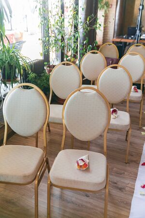 Creamy white wedding chairs in restaurant.の写真素材