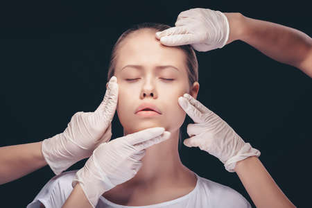 Portrait of young woman getting cosmetic injection. Clean Beauty. Closed eyes.の写真素材