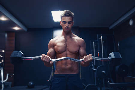 young man doing heavy weight exercise for biceps.の写真素材