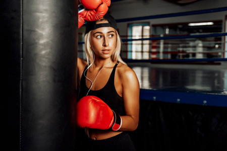 Beautiful Woman with the Red Boxing Gloves. Attractive Female Boxer Training.の写真素材