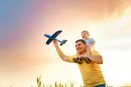 happy father with son playing with toy plane. dream to be a pilot.の写真素材