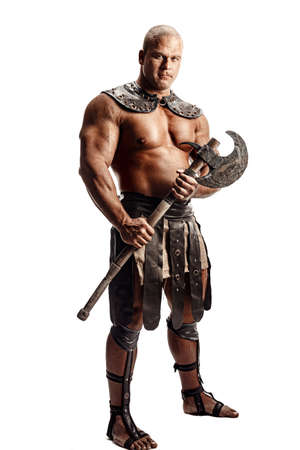 Studio shot of muscular ancient warrior man posing with axe. Isolated on white. Copy spaceの写真素材