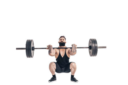 The technique of doing an exercise of deadlift with a barbell of a muscular strong tattooed bearded sports men on a white studio background. Isolate.の写真素材