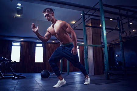 Young athlete doing exercises with a resistance band.