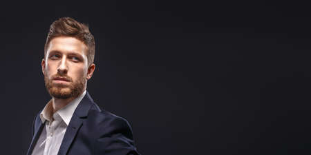 A man wearing a suit and tie on black backgroundの写真素材