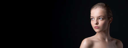 Fashionable woman with perfect face and clean skin on black backgroundの写真素材