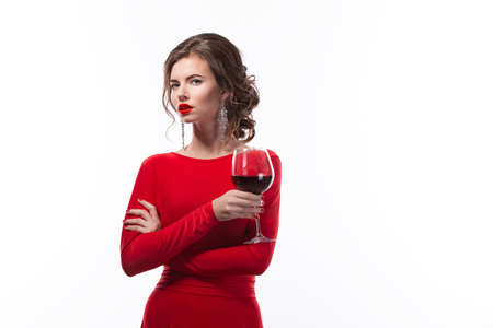 Beautiful woman holding glass of wine on white backgroundの写真素材
