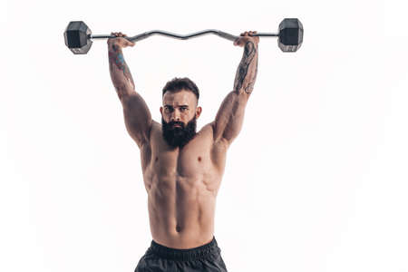 Muscular bodybuilder guy doing exercises with dumbbell over white backgroundの写真素材
