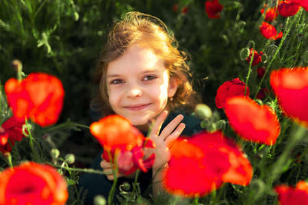 Girl in dress and straw hat outdoor At Poppy Fieldの写真素材