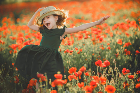 Girl in dress and straw hat outdoor At Poppy Fieldの写真素材