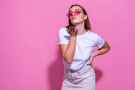 Young woman over isolated pink background with glasses