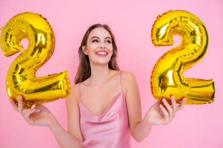 Girl holds foil balloons in the form of numbers twenty two percent. discounts, sales and cashback.の写真素材