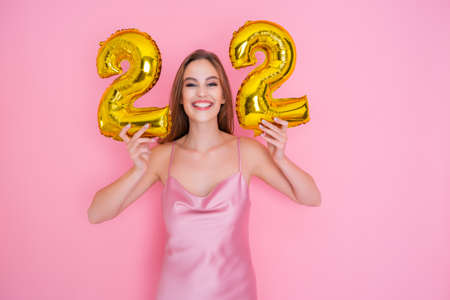 Girl holds foil balloons in the form of numbers twenty two percent. discounts, sales and cashback.の写真素材