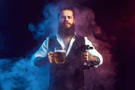 man holds dumbbell and mug of beer. choices alcohol or sport. Blowing smoke background