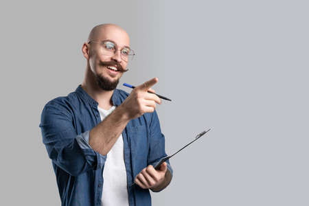 Smiling lecturer of university or college discusses with students new theory, while gesturing handの写真素材