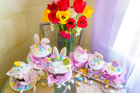 Beautiful Easter Russian cakes and Easter eggs on a decorated light table. A light holiday of Easter