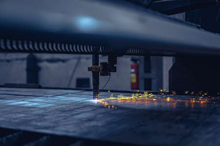 Fiber laser cutting CNC machine cuts metal list. Making metal part. Workshop in factoryの写真素材