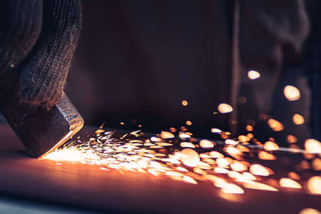 Closeup of Sparks that fly out when grinding metal details machine. Metallurgical Plantの写真素材