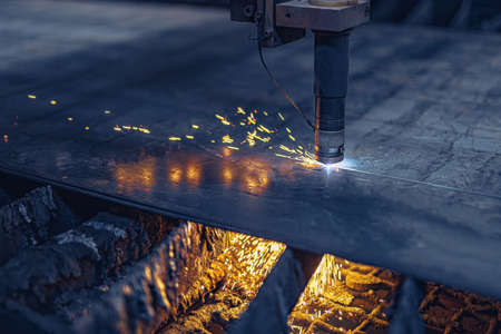 Fiber laser cutting CNC machine cuts metal list. Making metal part. Workshop in factory