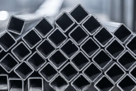 Steel tube, square high carbon metal tube for construction site. Metallurgy backgroundの写真素材