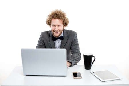 Portrait of curly hair smiling businessman with laptop isolated on white background.
