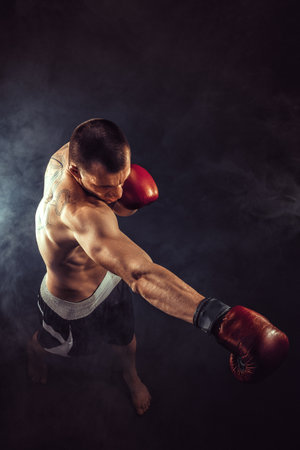 Muscular Kickbox Or Muay Thai Fighter Punching In Smokeの写真素材 イメージマート