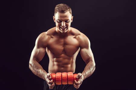 Power, strength, excellent body, bodybuilding, sports concept. Young handsome muscular fit man...