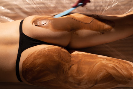 Treatment with chocolate cream to bottom skinの写真素材