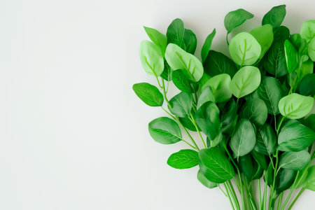 An arrangement of lush artificial leaves in varying shades of green captures the essence of nature, perfect for enhancing creative projects or adding a touch of freshness.の素材