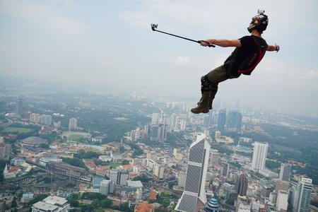 A BASE jumper in jumps off from KL Tower