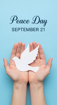 Global Peace Day: Human Hands Holding a White Paper Dove on September 21の素材