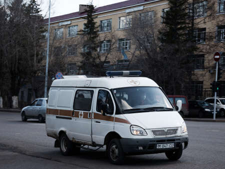 Ambulance van riding through city street. Old Gazell Car.のeditorial素材