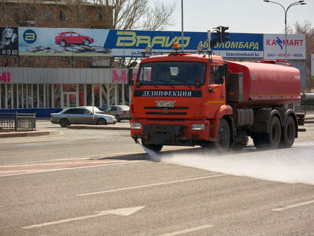 Karaganda, Kazakhstan - 11nd April, 2020 - a car with the Russian inscription "disinfection" disinfects the streets of the city to protect against COVID-19のeditorial素材