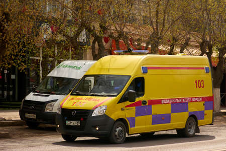 Karaganda, Kazakhstan - 23nd April, 2020: Ambulance van riding through city street.のeditorial素材