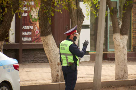 Karaganda, Kazakhstan - 23nd April, 2020: patrol officers check cars and documents with drivers during quarantine.のeditorial素材
