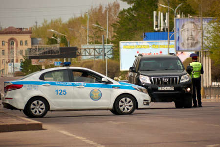 Karaganda, Kazakhstan - 23nd April, 2020: patrol officers check cars and documents with drivers during quarantine.のeditorial素材