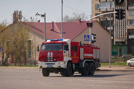 Karaganda/Kazakhstan - 22.04.2020: Fire engine driving fast on a road in an emergency.