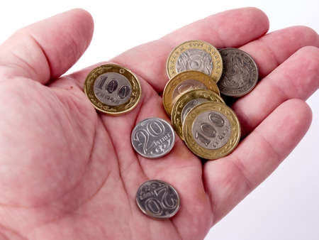 different tenge coins lie in a mans palm