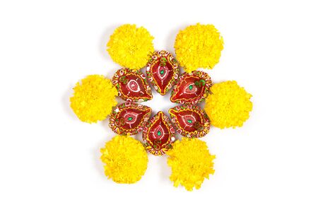 Happy Diwali - Clay Diya lamps lit during Dipavali, Hindu festival of lights celebration. Colorful traditional oil lamp diya on white background. Copy space for text.の写真素材