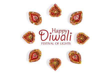 Happy Diwali - Clay Diya lamps lit during Diwali, Hindu festival of lights celebration. Colorful traditional oil lamp diya on white background. Copy space for text.の写真素材