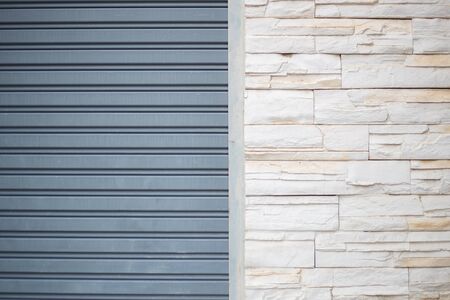 White misty brick wall for background or texture adjacent to Electrical Stainless steel door.の写真素材